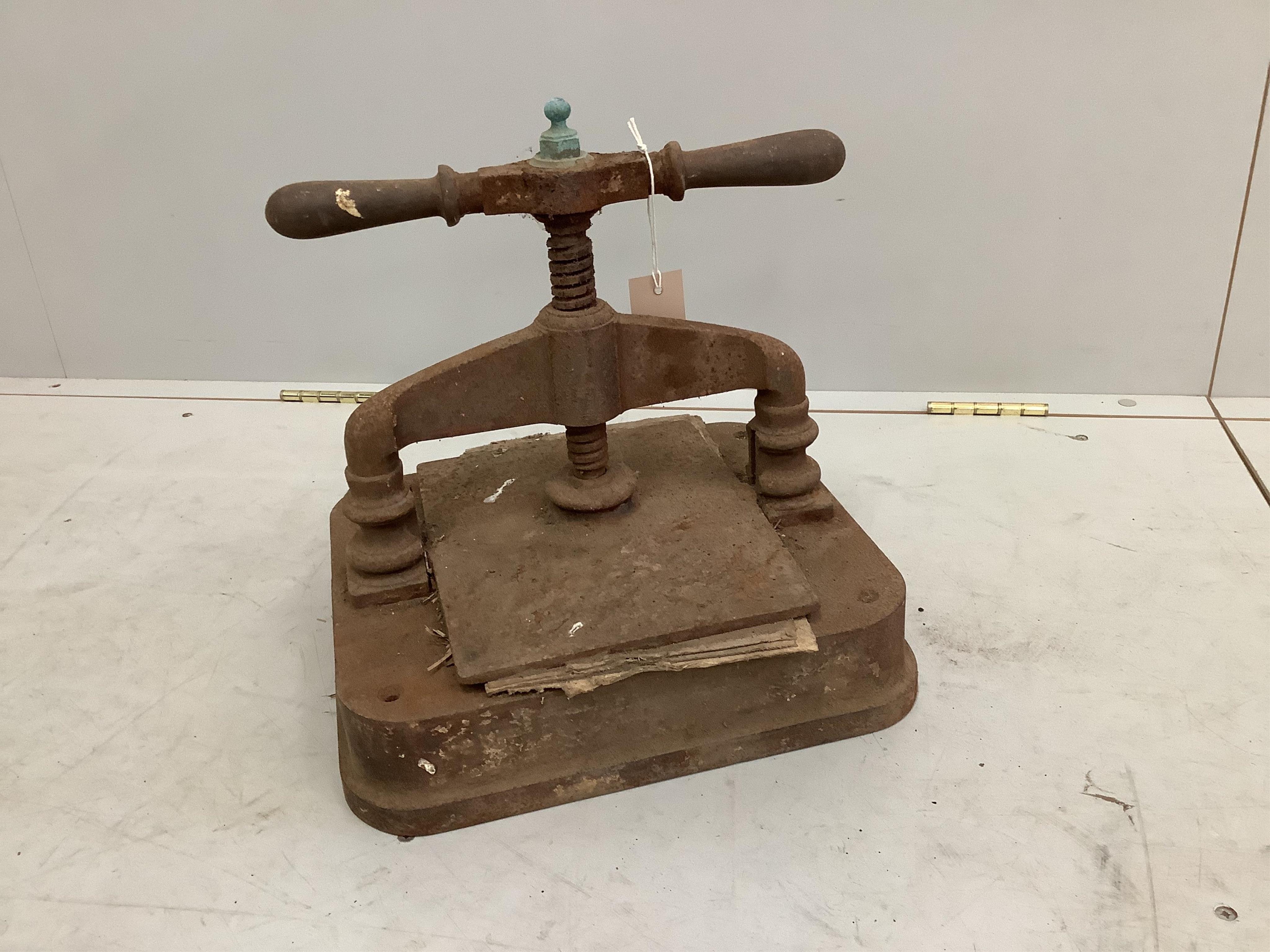 A Victorian cast iron book press, height 30cm. Condition - poor